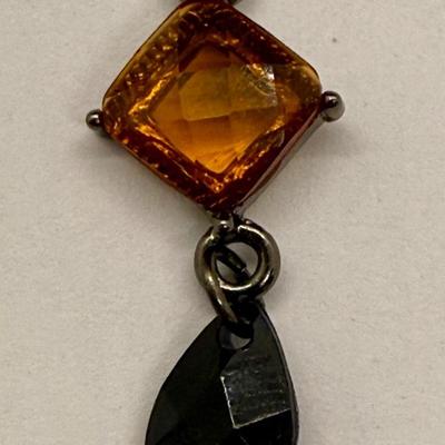 Sale Photo Thumbnail #12: For pierced ears, has a diamond-shaped translucent amber stone above a dark teardrop. Good condition.