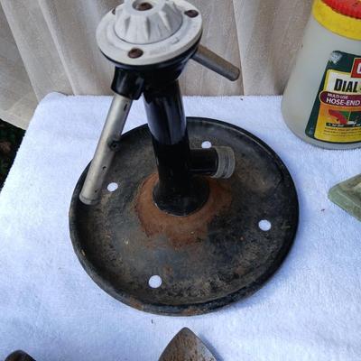 Assortment of yard sprinklers, small hand - tools, and a sprayer