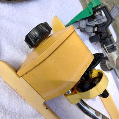 Assortment of yard sprinklers, small hand - tools, and a sprayer