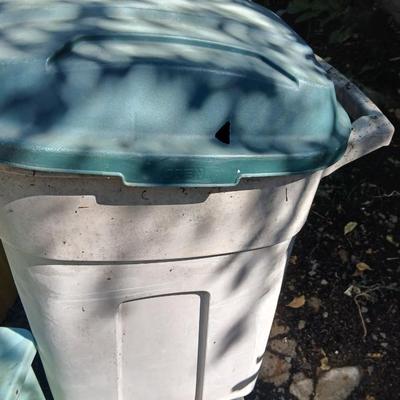 Large sized rolling garbage bin with several smaller plastic trash cans / containers
