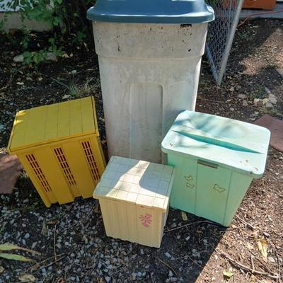 Large sized rolling garbage bin with several smaller plastic trash cans / containers