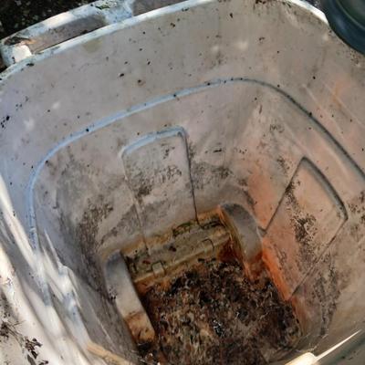 Large sized rolling garbage bin with several smaller plastic trash cans / containers