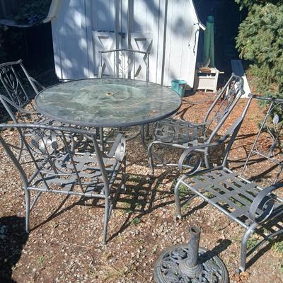 Martha Stewart patio table with etched glass and lazy susan comes with 5 metal chairs and weighted umbrella stand