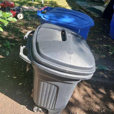 Large rolling back trash can and a blue recycle rolling bin