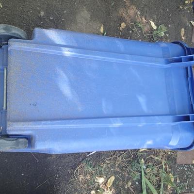 Large rolling back trash can and a blue recycle rolling bin