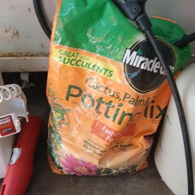 Ortho Home defense insect killer with two-yard weed sprayers and a partial bag of potting soil