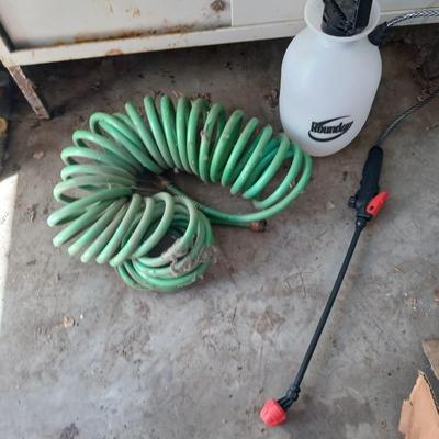 Garden hose, garden sprayer and a small broom with dustpan