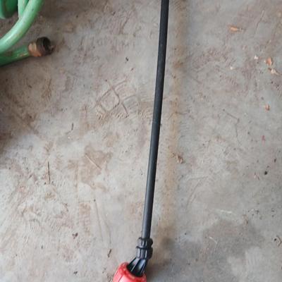 Garden hose, garden sprayer and a small broom with dustpan