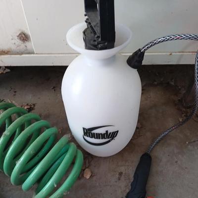 Garden hose, garden sprayer and a small broom with dustpan