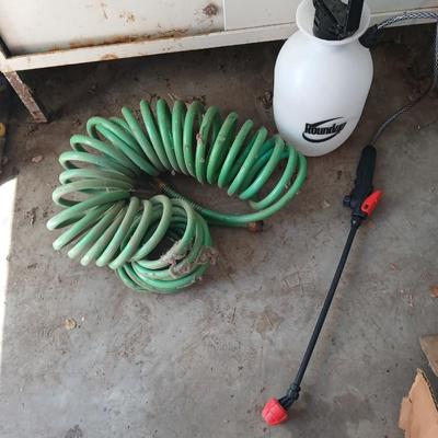 Garden hose, garden sprayer and a small broom with dustpan