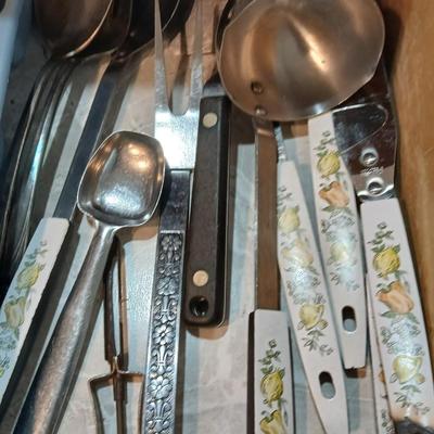 Drawer organizer full of assorted mis-matched flatware and a nice utensil set