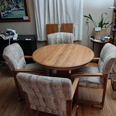 Oak diningroom table with claw foot base - 4 fabric covered chairs and two table leafs.
