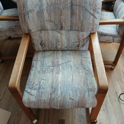 Oak diningroom table with claw foot base - 4 fabric covered chairs and two table leafs.