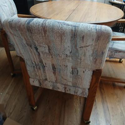 Oak diningroom table with claw foot base - 4 fabric covered chairs and two table leafs.