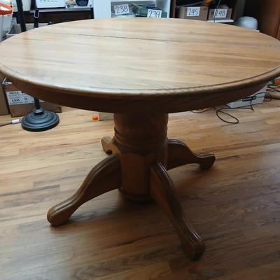 Oak diningroom table with claw foot base - 4 fabric covered chairs and two table leafs.
