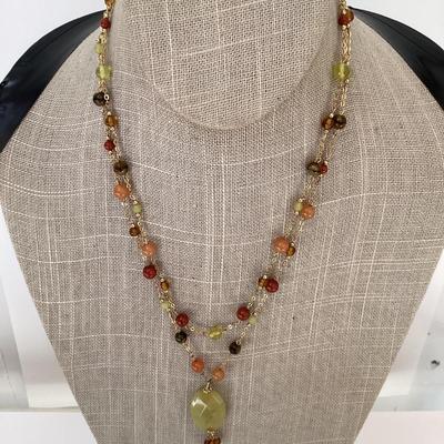 Warm toned necklace and earring set. Green stone