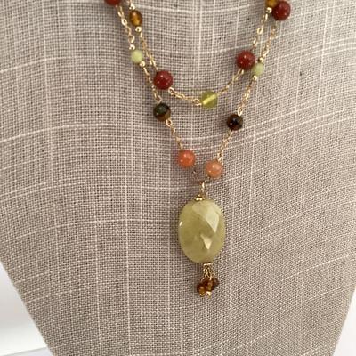 Warm toned necklace and earring set. Green stone