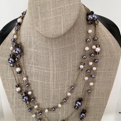 Multi strand necklace with purple and white beads