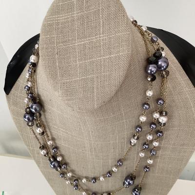 Multi strand necklace with purple and white beads