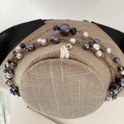 Multi strand necklace with purple and white beads