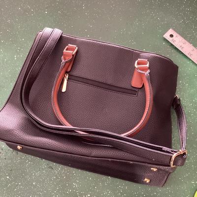 black and brown hand bag labeled Prada