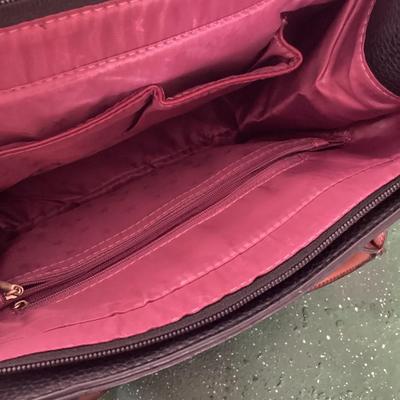 black and brown hand bag labeled Prada