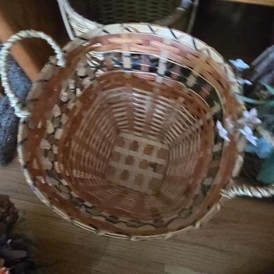 Large lot of wicker baskets, a faux plant, wall art and more
