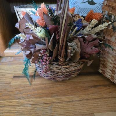 Large lot of wicker baskets, a faux plant, wall art and more