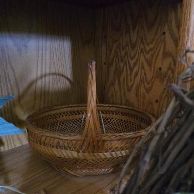 Large lot of wicker baskets, a faux plant, wall art and more