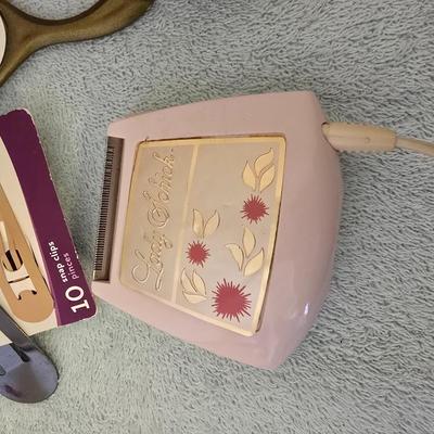 Bathroom scale - curling irons - hairdryer - and an assortment of other beauty products