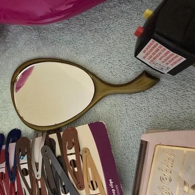 Bathroom scale - curling irons - hairdryer - and an assortment of other beauty products