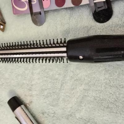 Bathroom scale - curling irons - hairdryer - and an assortment of other beauty products