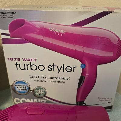 Bathroom scale - curling irons - hairdryer - and an assortment of other beauty products