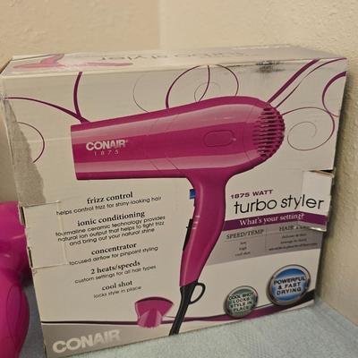 Bathroom scale - curling irons - hairdryer - and an assortment of other beauty products