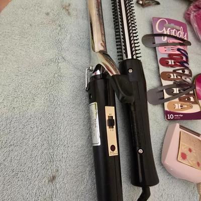 Bathroom scale - curling irons - hairdryer - and an assortment of other beauty products