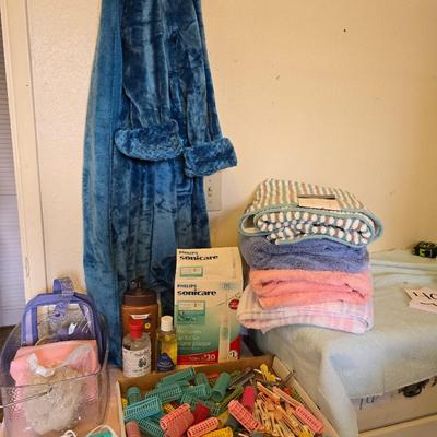 Bath robe, hair curlers, assortment of beauty liquids, brand new bath towel and two other nice towels
