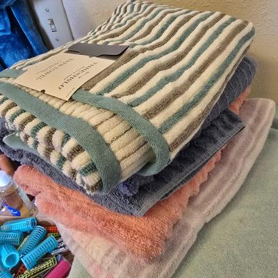 Bath robe, hair curlers, assortment of beauty liquids, brand new bath towel and two other nice towels