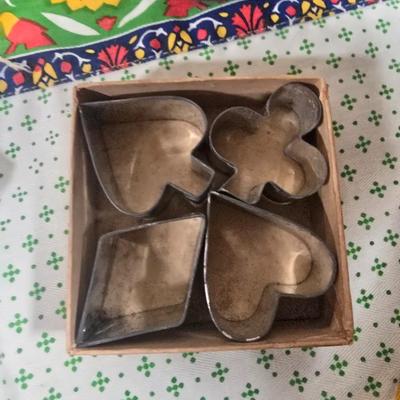 LOT 123: Copper Bundt Pans with Vintage Kitchen Gadgets and Cookie Cutters, Betty Crocker Points, Aprons, Tea Towels and Napkins