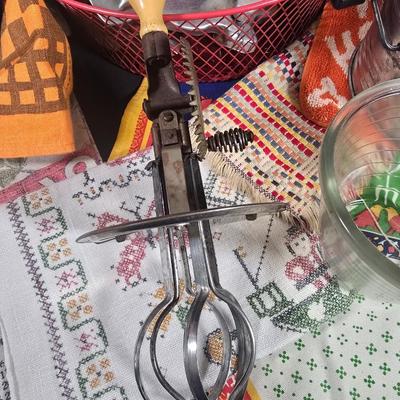 LOT 123: Copper Bundt Pans with Vintage Kitchen Gadgets and Cookie Cutters, Betty Crocker Points, Aprons, Tea Towels and Napkins