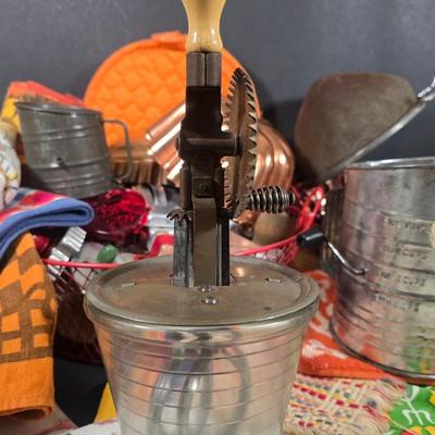 LOT 123: Copper Bundt Pans with Vintage Kitchen Gadgets and Cookie Cutters, Betty Crocker Points, Aprons, Tea Towels and Napkins