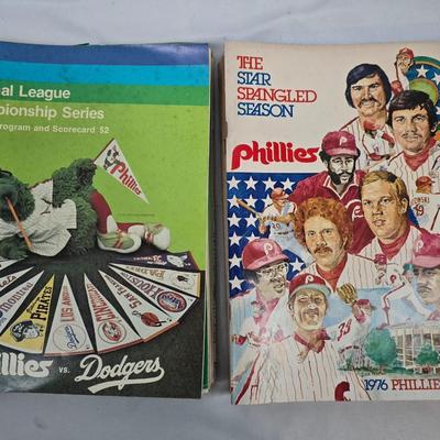 LOT 125: Vintage Phillies Yearbooks, Posters, Ticket Stubs with Pete Rose Newspaper Clipping and Baseball Book
