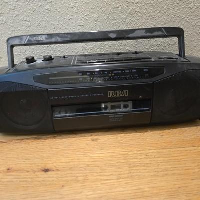 RCA Dual cassette deck am/fm radio with assortment of books on tape