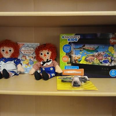 Raggedy Ann & Andy dolls and DVD movie with a discovery kids aquarium and a pair of funny glasses
