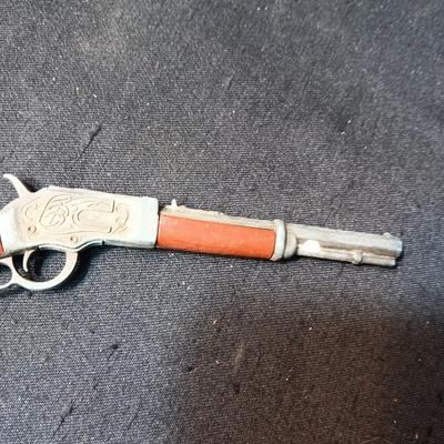 TOY WINCHESTER RIFLE AND A SMOKY CAP GUN