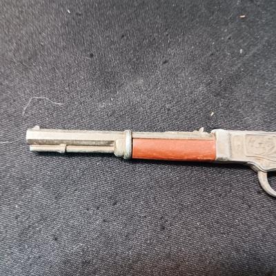 TOY WINCHESTER RIFLE AND A SMOKY CAP GUN