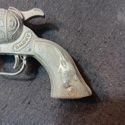 TOY WINCHESTER RIFLE AND A SMOKY CAP GUN