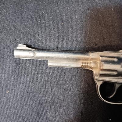 PET TOY CAP GUN WITH A BOX OF ROLLED CAPS AND A SMALLER METAL TOY GUN