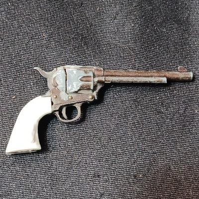 PET TOY CAP GUN WITH A BOX OF ROLLED CAPS AND A SMALLER METAL TOY GUN