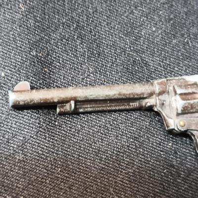 PET TOY CAP GUN WITH A BOX OF ROLLED CAPS AND A SMALLER METAL TOY GUN