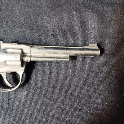 PET TOY CAP GUN WITH A BOX OF ROLLED CAPS AND A SMALLER METAL TOY GUN